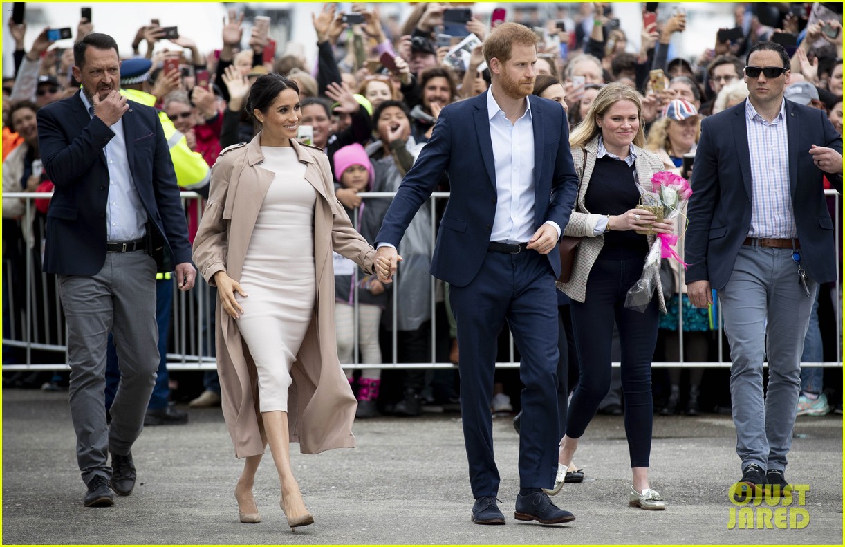 Duchess Meghan Markle Cradles Her Baby Bump During Outing with Prince(01)