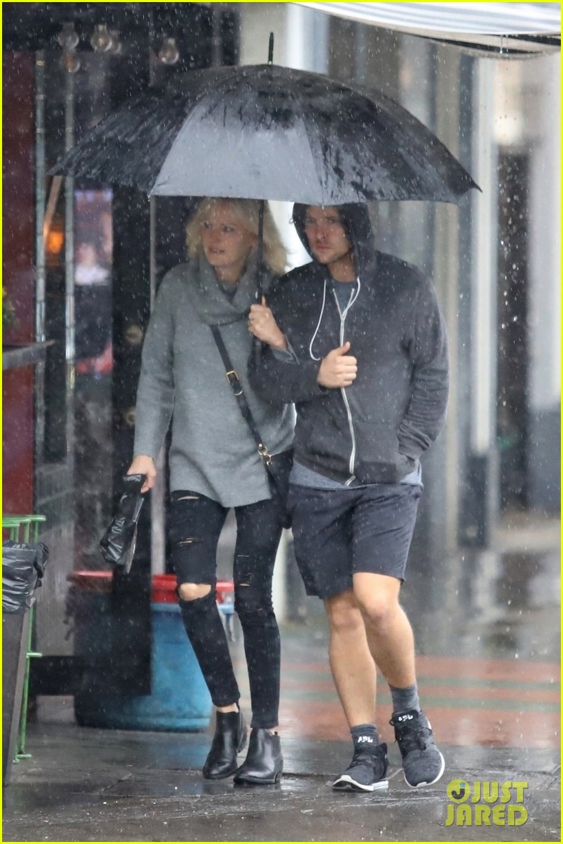 malin akerman braves the downpours with husband jack donnelly 034221272