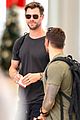 chris hemsworth shows some muscle at the airport 02