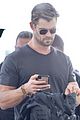 chris hemsworth shows some muscle at the airport 04