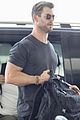 chris hemsworth shows some muscle at the airport 06