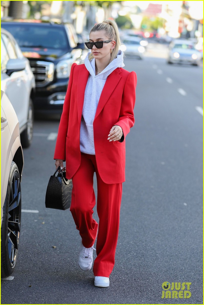 hailey bieber red suit dog ruins tree 054397078