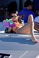 kendall jenner wears tiny orange bikini reading on boat 03