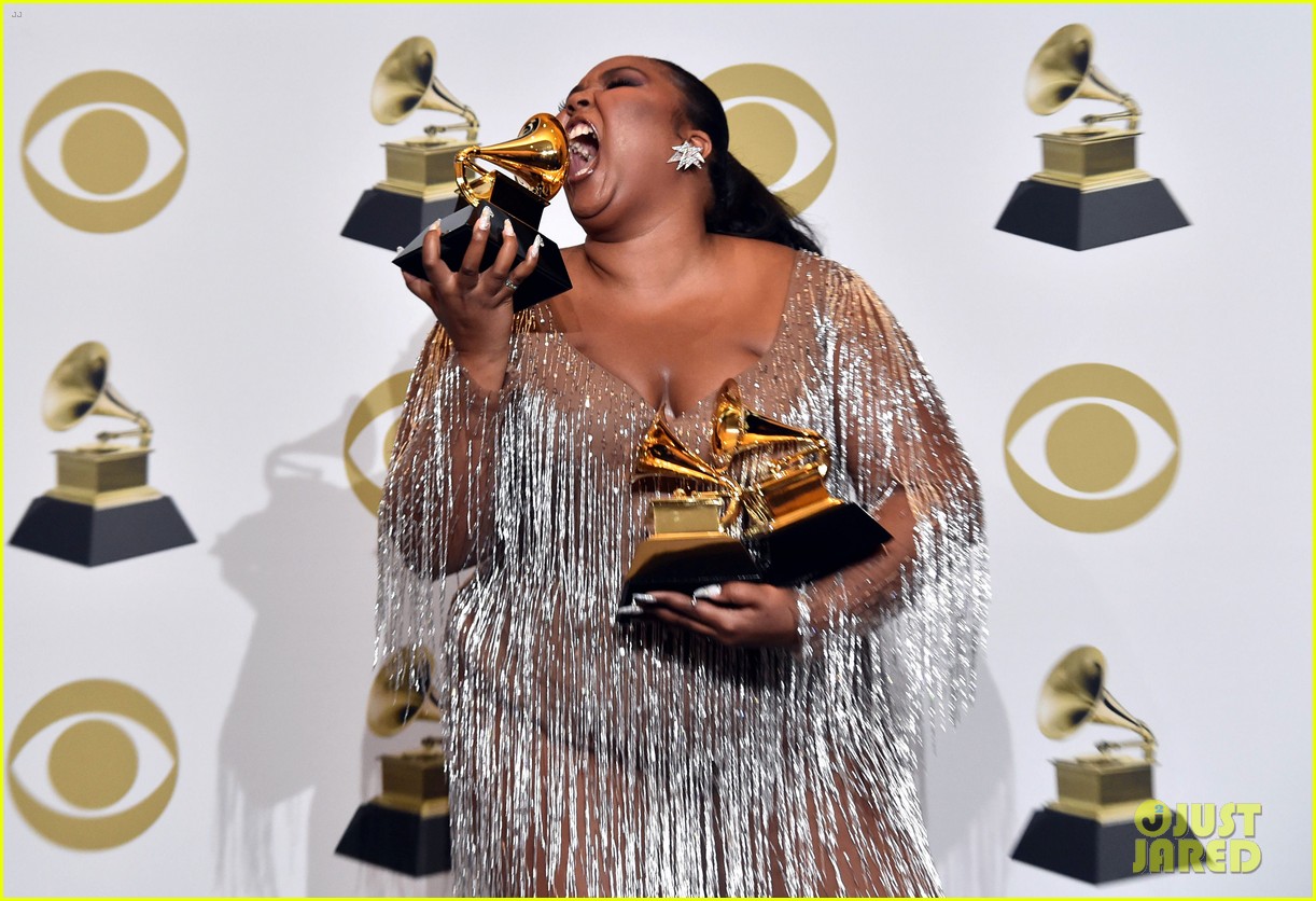 lizzo dazzles in silver posing with grammy awards 06