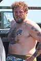 jonah hill shows off tattoos stripping out of wetsuit 03