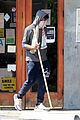 chadwick boseman walks with a walking stick 08