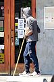 chadwick boseman walks with a walking stick 35