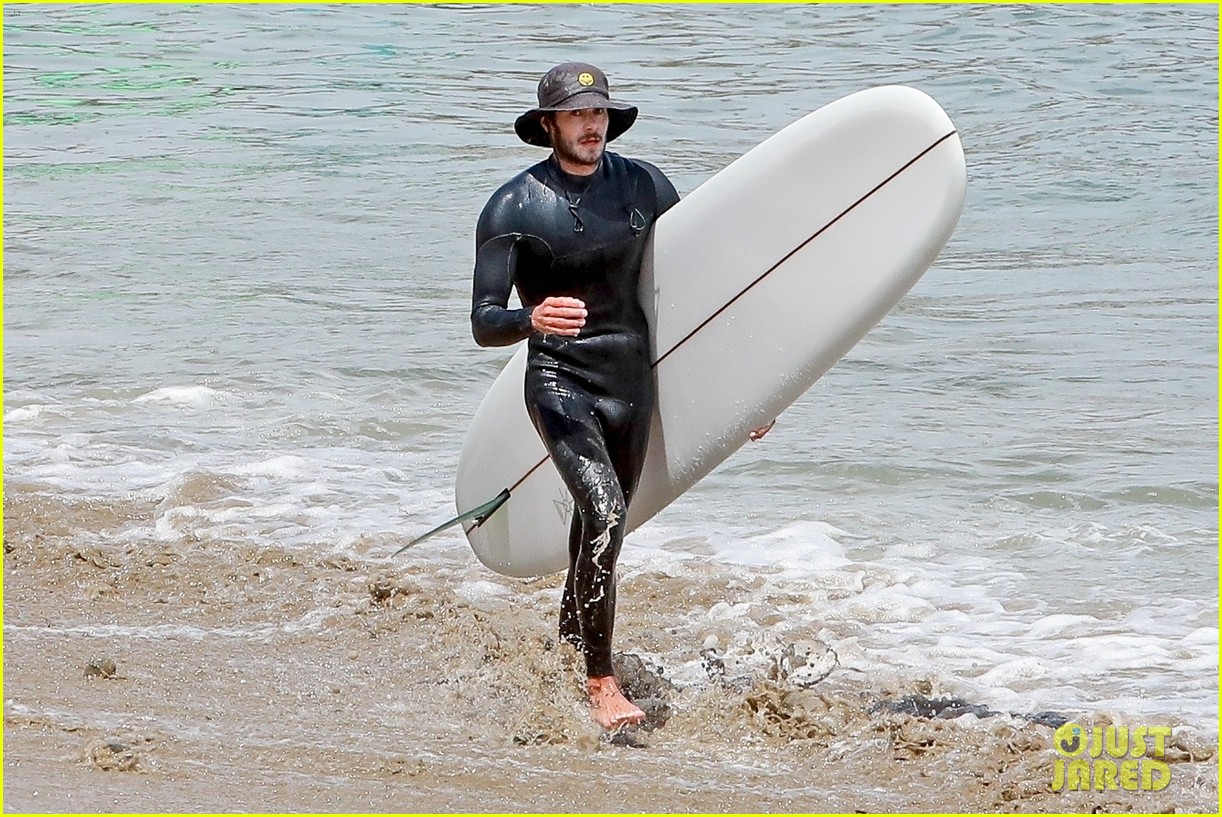 adam brody goes surfing in his wetsuit 054461575