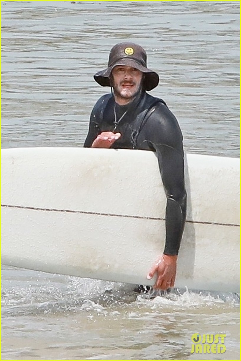 adam brody goes surfing in his wetsuit 074461577