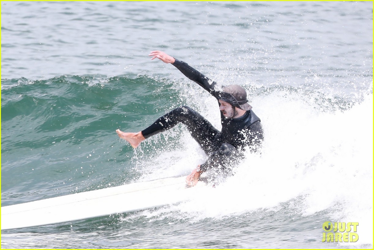 adam brody goes surfing in his wetsuit 16