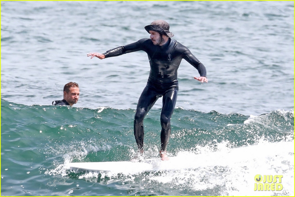 adam brody goes surfing in his wetsuit 244461594