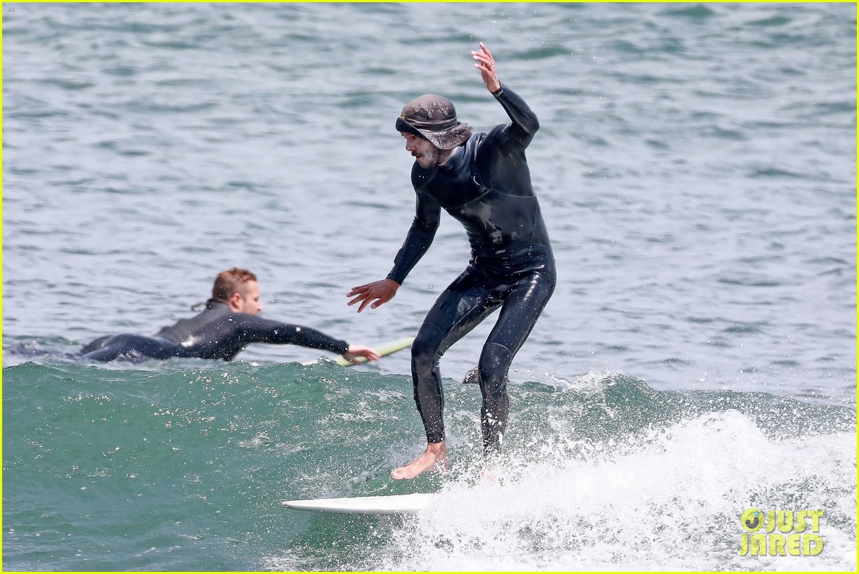 adam brody goes surfing in his wetsuit 304461600