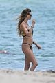 behati prinsloo at the beach while adam levine works out 03