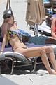 behati prinsloo at the beach while adam levine works out 13