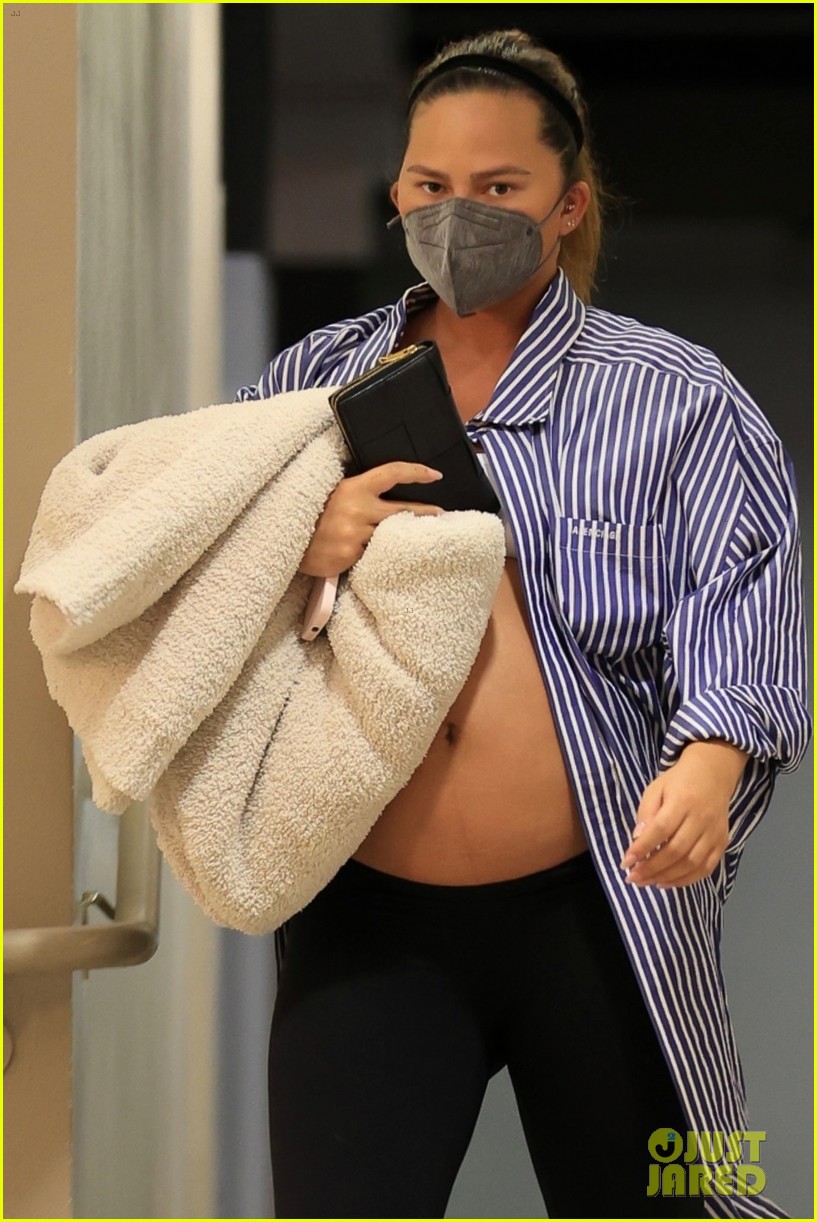 Chrissy Teigen Bares Large Baby Bump While Wearing an Unbuttoned Shirt