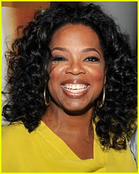 Oprah Winfrey Strains Back Lifting Birthday Flowers
